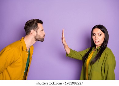 Profile photo of couple boyfriend wait contact want kissing responsible girlfriend stop him raise arm keep distance terrified wear colorful shirts isolated purple color background
