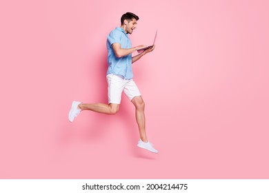 Profile Photo Of Crazy Excited Man Jump Work Laptop Run Hurry Wear Blue Shirt Shorts Isolated On Pink Color Background