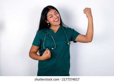 Profile Photo Of Excited Doctor Hispanic Woman Wearing Surgeon Uniform Over White Background Good Mood Raise Fists Screaming Rejoicing Overjoyed Basketball Sports Fan Supporter