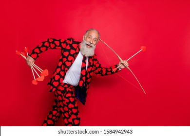 Profile Photo Of Excited Funky Aged Man Guy Cupid See Nice Couple Going To Shoot Love Bow Arrow Wear Hearts Pattern Suit Shirt Tie Pants Isolated Shine Red Color Background