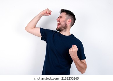 Profile Photo Of Excited Young Caucasian Man Wearing Black T-shirt Over White Background Good Mood Raise Fists Screaming Rejoicing Overjoyed Basketball Sports Fan Supporter