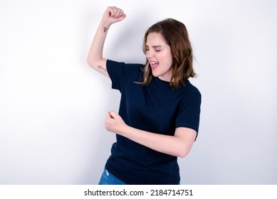 Profile Photo Of Excited Young Caucasian Woman Wearing Black T-shirt Over White Background Good Mood Raise Fists Screaming Rejoicing Overjoyed Basketball Sports Fan Supporter