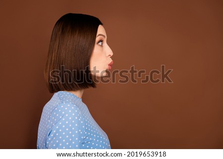 Profile photo of flirty bob hairdo millennial lady kiss empty space wear blue blouse isolated on brown color background