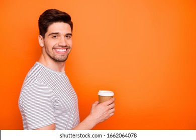 Profile photo of funny attractive cheerful guy hold hand hot takeout coffee beverage friendly toothy smiling wear striped t-shirt isolated bright orange color background - Powered by Shutterstock