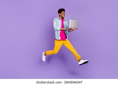 Profile Photo Of Guy Jump Hold Computer Run Fast Wear Blue Shirt Pants Sneakers Isolated Purple Color Background