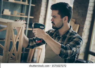 Profile photo of handsome guy building book shelf handmade design assembling using drill wooden industry home woodwork workshop indoors - Powered by Shutterstock