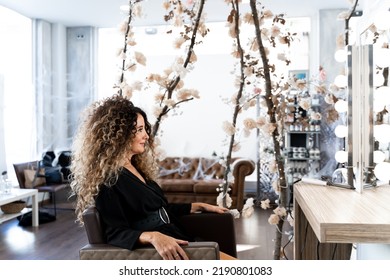 Profile Photo Of A Mature Woman Sitting On A Hairdresser Salon In Front Of A Mirror