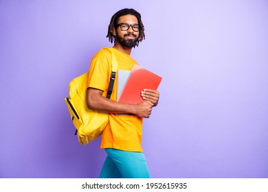 Profile photo of nice optimistic brunet guy hold books wear spectacles bag orange t-shirt isolated on vibrant lilac background - Powered by Shutterstock