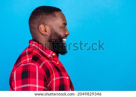 Profile photo of optimistic millennial brunet guy wear plaid shirt isolated on blue color background