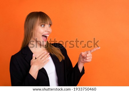 Profile photo of optimistic nice blond hair lady point empty space wear black jacket isolated on bright orange color background