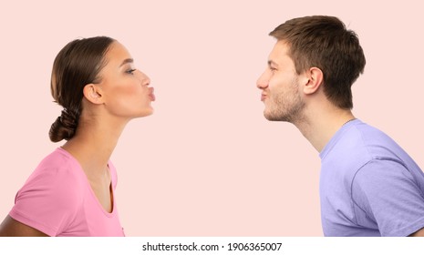 Profile Photo Portrait Of Young Beautiful People Reaching To Each Other And Trying To Kiss, Man And Woman Expressing Love And Affection, Isolated Over Pastel Pink Studio Background, Copy Space