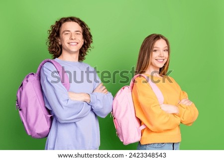 Profile photo of two cheerful intelligent people crossed arms toothy smile isolated on green color background Foto stock © 