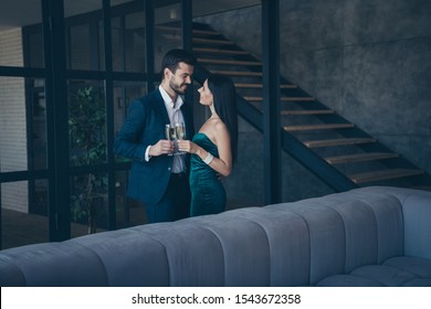 Profile Photo Of Two Classy Stylish Trendy People Couple Wealthy Guy And Lady Standing Close Looking Eyes Drinking Sparkling Wine Romance Date Wear Fancy Formalwear Suit Loft Industrial Indoors