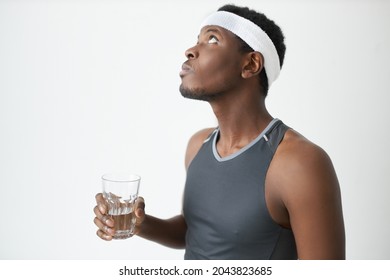 Profile Picture Of Handsome African Fitness Guru Holding Glass Of Water In Hands Putting Head Back Mouth Washing, Gargling, Getting Ready To Fitness Training, Looking Good In Sportswear And Headband