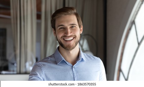 Profile Picture Of Happy Friendly Young Man Corporate Staff Member Posing For Portrait In Modern Office Space Looking At Camera With Smile Satisfied With Self Realization In Job Career Opportunities