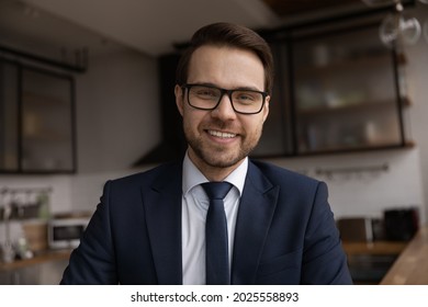 Profile picture head shot confident 30s businessman in suit and glasses smile look at camera. Professional counselling remotely due covid, videoconference talk, modern tech, video call event concept - Powered by Shutterstock