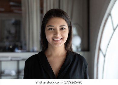 Profile picture of smiling indian young businesswoman look at camera posing at workplace, headshot portrait of happy millennial ethnic female employee show confidence, optimism, employment concept - Shutterstock ID 1779265490
