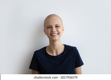 Profile picture of smiling young hairless sick woman struggle fight with oncology isolated on grey studio background. Headshot portrait of bald ill female patient suffer from cancer, beat sickness.