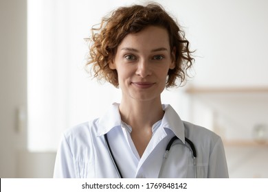 Profile Picture Of Young Caucasian Woman Doctor Or GP In White Medical Uniform Look At Camera In Hospital Posing, Headshot Portrait Of Smiling Female Nurse Or Physician Show Confidence Professionalism