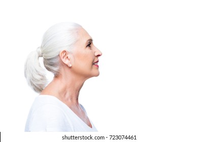 profile portrait of attractive smiling senior woman, isolated on white