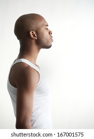 Profile Portrait Of A Black Man Standing On White Background