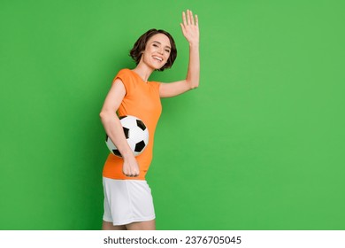 Profile portrait of charming positive girl toothy smile arm palm wave look camera isolated on green color background - Powered by Shutterstock