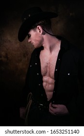 Profile Portrait Of Cowboy Wearing Hat With Open Black Shirt Revealing Defined Pecs And Sixpack Abs