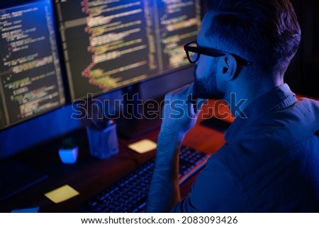 Profile portrait of intelligent minded person hand on chin look two monitors debugging database house loft space