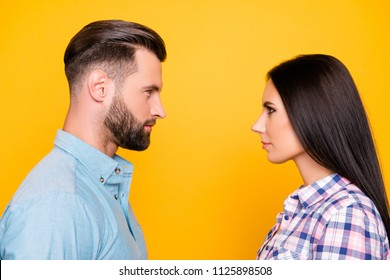 Profile Portrait Of Jealous Angry Couple Standing Face To Face Having Problem Conflict Isolated On Vivid Yellow Background. Psychology Concept