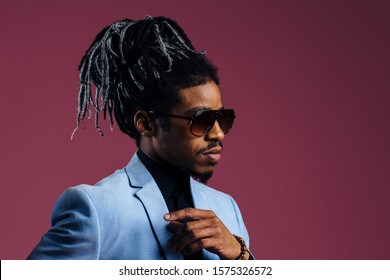 Profile Portrait Of A Man With Cool Hair And Sunglasses, Against Studio Background