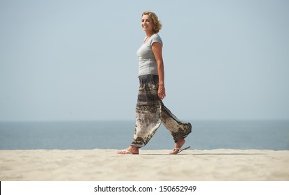 Profile Portrait Of A Mature Woman Walking At The Beach