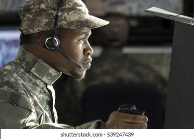 Profile Portrait Of A Military Drone Operator At His Computer