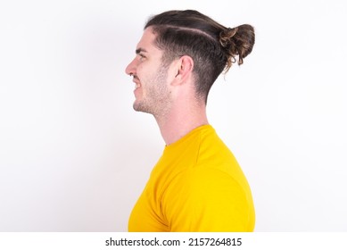Profile portrait of nice Young caucasian man wearing yellow t-shirt over white background look empty space toothy smile - Shutterstock ID 2157264815
