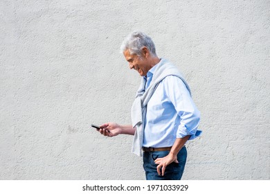 Profile Portrait Older Man Holding Mobile Phone Against White Wall