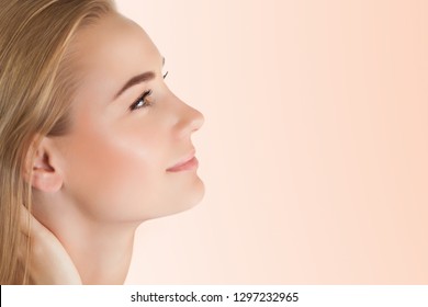 Profile portrait of a pretty woman with perfect skin isolated on clear background, using anti acne or anti aging cream, health and beauty care concept
