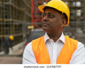 Profile Portrait Of A Serious Civil Engineer Or Factory Worker Wearing A Safety Helmet And Looking Aside