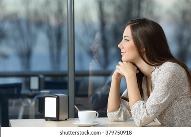 Profile Portrait Of A Serious Woman Thinking In A Coffee Shop Looking Through The Window In A Bad Day