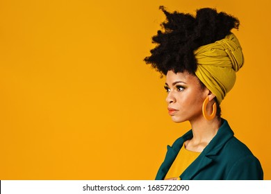 Profile Portrait Of A Serious Young Woman With Big Yellow Earrings And Afro Hair Wrapped With Head Wrap Scarf