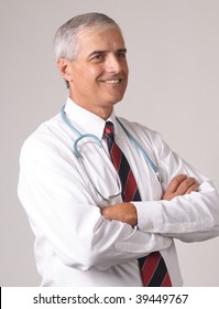 Profile Portrait Of Smiling Middle Aged  Doctor With Stethoscope And Arms Crossed