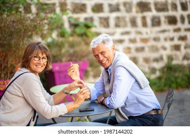 Profile Portrait Smiling Older Couple Drinking Cup Of Coffee Outside