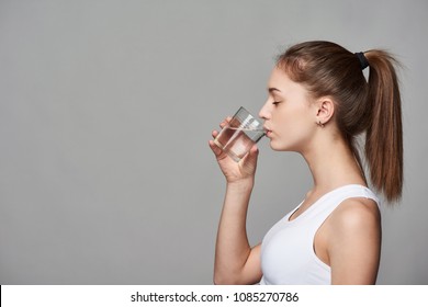 Profile Portrait Of Sporty Teen Girl Drinking Clear Water With Closed Eyes