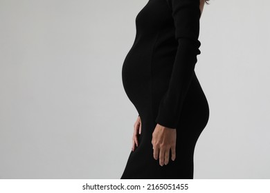 Profile Portrait Of Woman On Second Trimester Of Pregnancy. Expecting A Child.