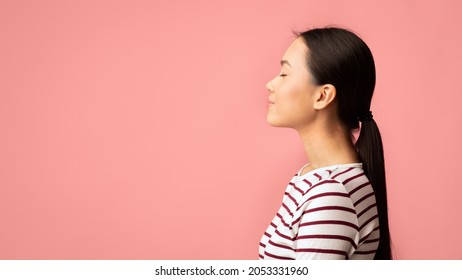 Profile Portrait Of Young Calm Asian Female Standing With Closed Eyes Over Pink Background, Side View Shot Of Relaxed Peaceful Millennial Korean Woman Posing In Studio, Panorama With Copy Space