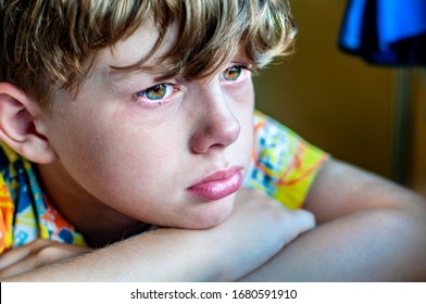 Profile Of A Sad Crying Boy With A Tear On His Cheek. The Child Is Grieving. The Child Is Mourning The Loss. Bullying At School. The Crisis Of Schoolchildren. Sorrow For The Victims Of Coronavirus