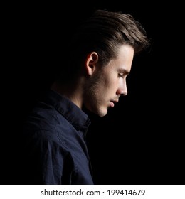 Profile Of A Sad Man Face Crestfallen On Black Isolated On A Black Background       