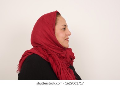 Profile Of Serious Muslim Woman With Healthy Pure Skin Has Contemplative Expression Ready To Have Outdoor Walk Isolated Over Grey Studio Wall With Copy Space.