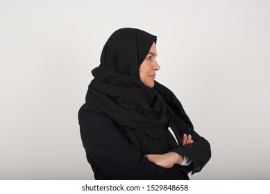 Profile Of Serious Muslim Womann With Healthy Pure Skin Has Contemplative Expression Ready To Have Outdoor Walk Isolated Over Grey Studio Wall With Copy Space.