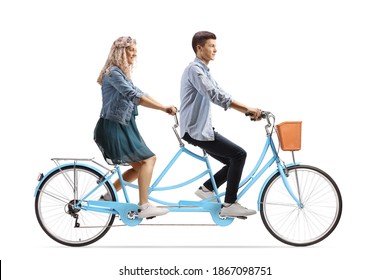 Profile shot of a casual young man and woman riding on a tandem bicycle isolated on white background - Powered by Shutterstock