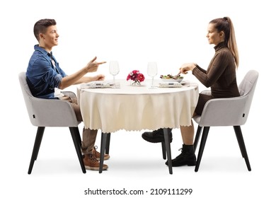 Profile shot of a casual young man and woman sitting at a restaurant table and talking isolated on white background - Powered by Shutterstock