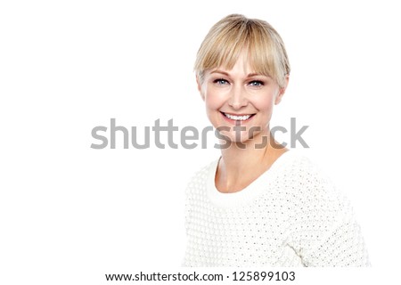 Profile shot of fashionable blonde woman facing camera and smiling.